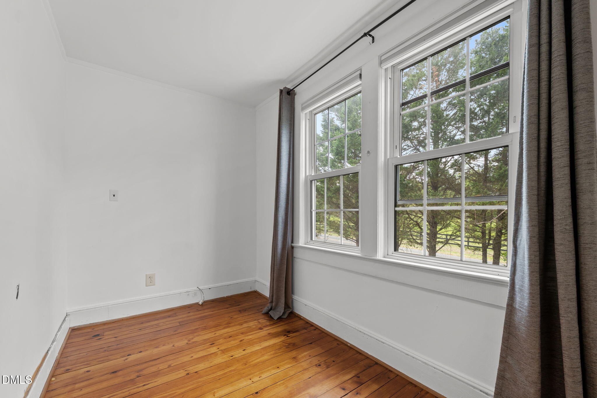 8718 Moody Road Liberty, NC 27298 - Photo 25 of 52 a view of an empty room with wooden floor and a window