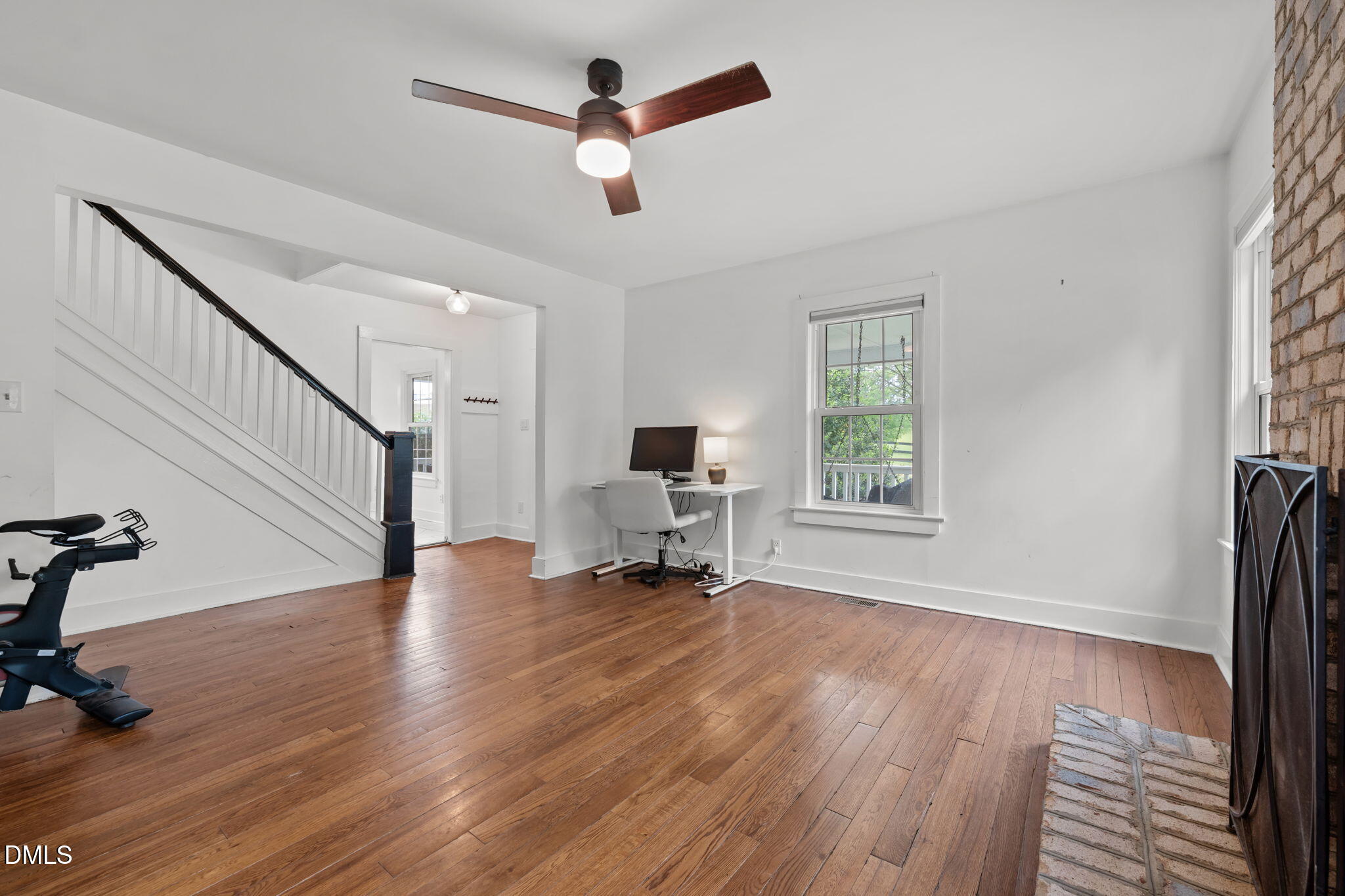8718 Moody Road Liberty, NC 27298 - Photo 6 of 52 a view of a livingroom with wooden floor and a ceiling fan