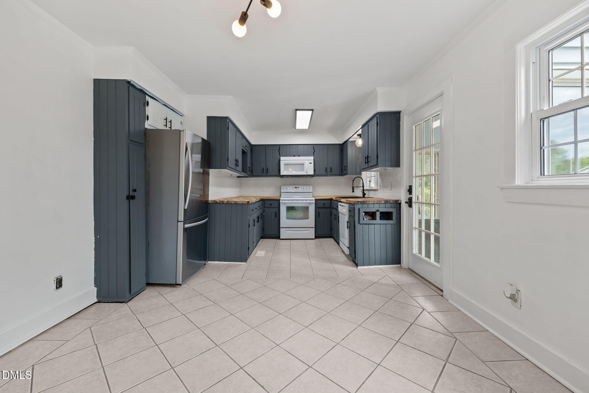 8718 Moody Road Liberty, NC 27298 - Photo 8 of 52 a kitchen with stainless steel appliances a refrigerator sink and cabinets