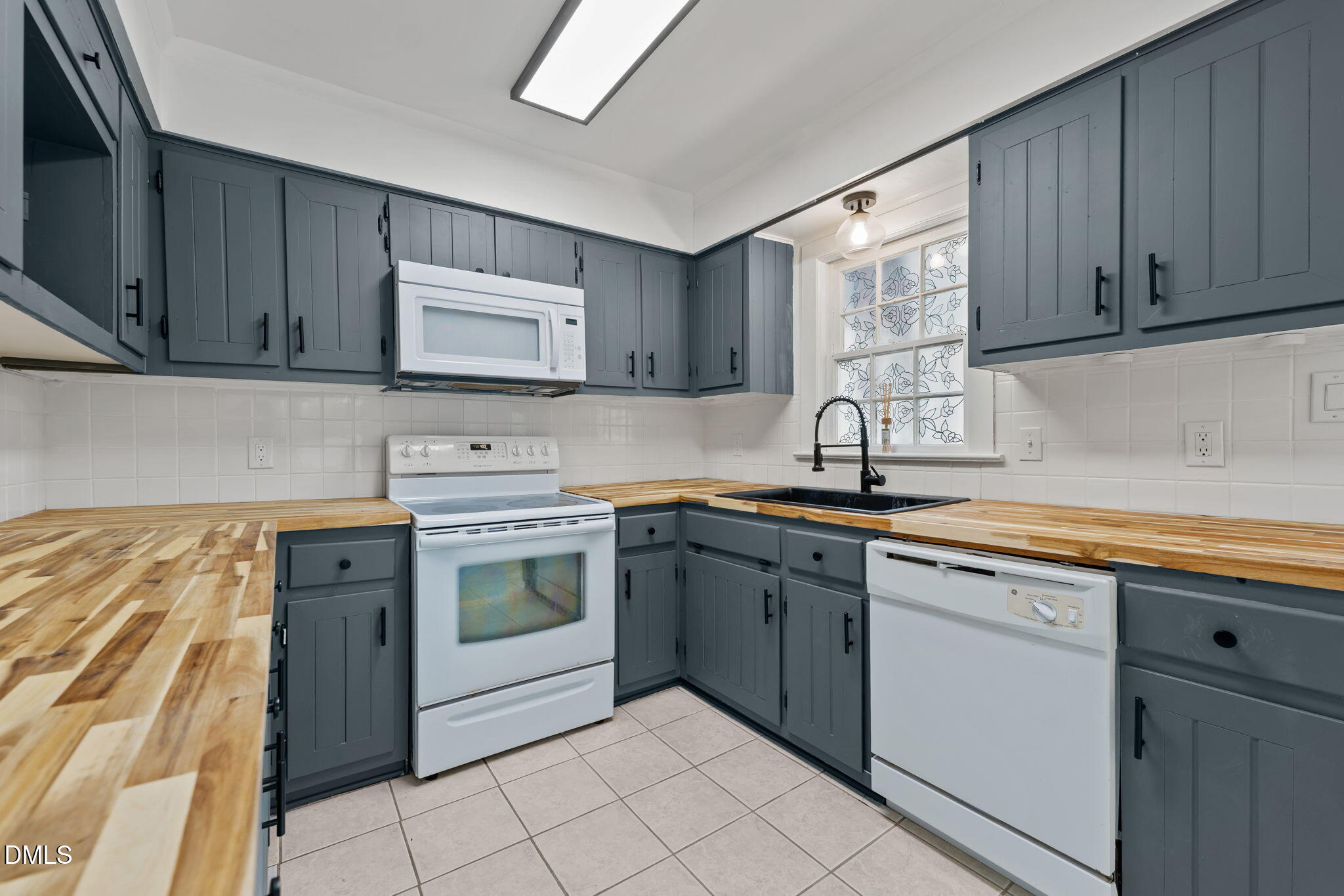 8718 Moody Road Liberty, NC 27298 - Photo 10 of 52 a kitchen with stainless steel appliances granite countertop a sink and cabinets