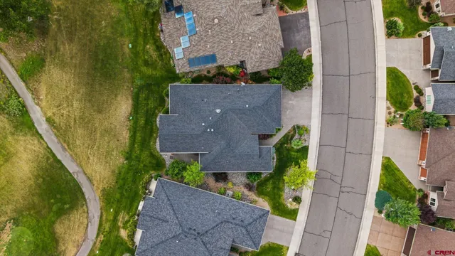 an aerial view of a house with outdoor space and a lake view