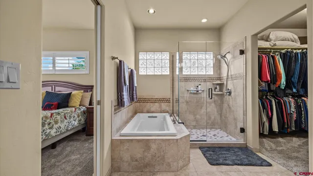 a bathroom with a tub sink and shower