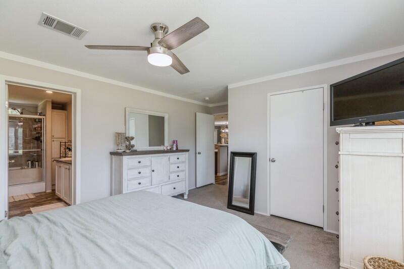 4488 Creek Road Vernon, FL 32462 - Photo 21 of 35 a bedroom with a bed and a flat screen tv