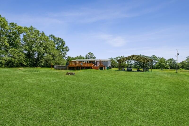 4488 Creek Road Vernon, FL 32462 - Photo 34 of 35 a green field with lots of trees in it