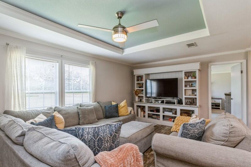 4488 Creek Road Vernon, FL 32462 - Photo 8 of 35 a living room with furniture a flat screen tv and a large window