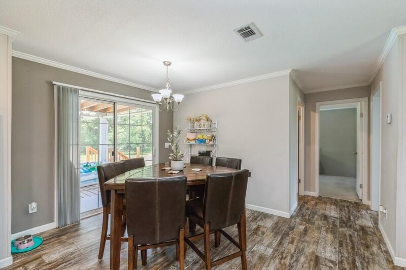 4488 Creek Road Vernon, FL 32462 - Photo 10 of 35 a view of a dining room with furniture window and wooden floor