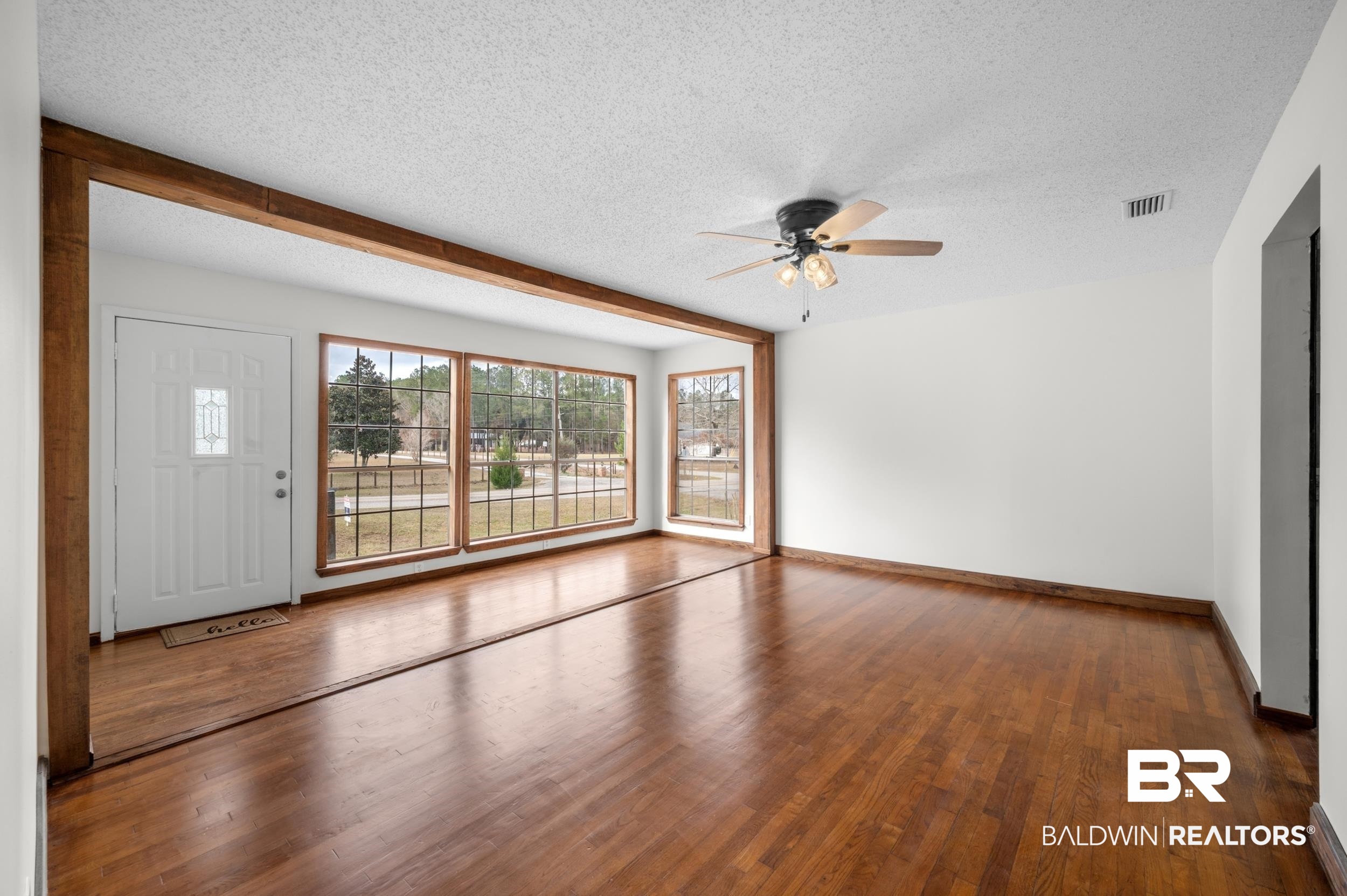 35780 Spring Road North Stapleton, AL 36578 - Photo 9 of 41 Unfurnished living room with dark wood finished floors, a textured ceiling, and a ceiling fan