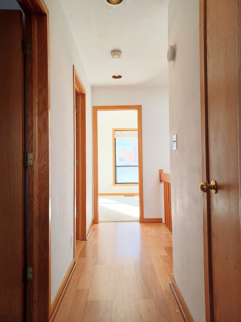 727 South Ashland Avenue, Unit D Chicago, IL 60607 - Photo 20 of 32 a view of a hallway with wooden floor and closet area