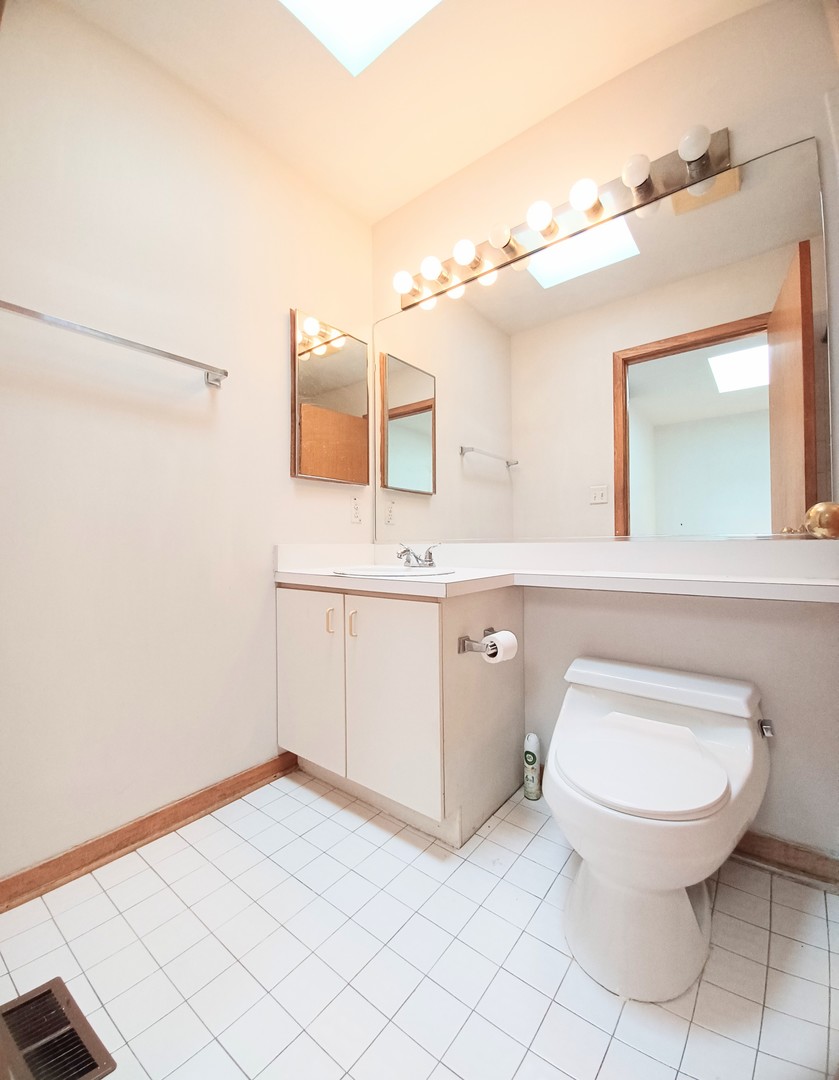727 South Ashland Avenue, Unit D Chicago, IL 60607 - Photo 22 of 32 a bathroom with a sink a toilet and mirror