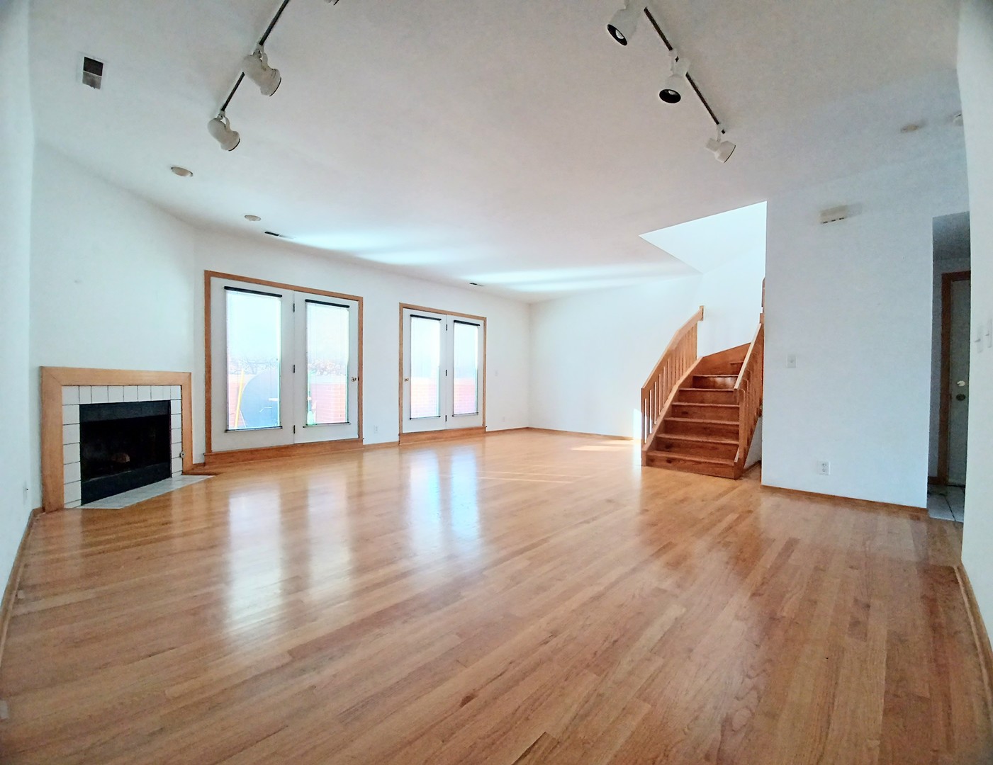 727 South Ashland Avenue, Unit D Chicago, IL 60607 - Photo 5 of 32 a view of empty room with wooden floor and fireplace