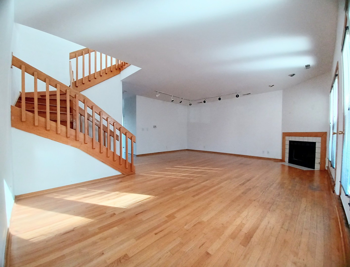 727 South Ashland Avenue, Unit D Chicago, IL 60607 - Photo 7 of 32 a view of an empty room with wooden floor and a fireplace