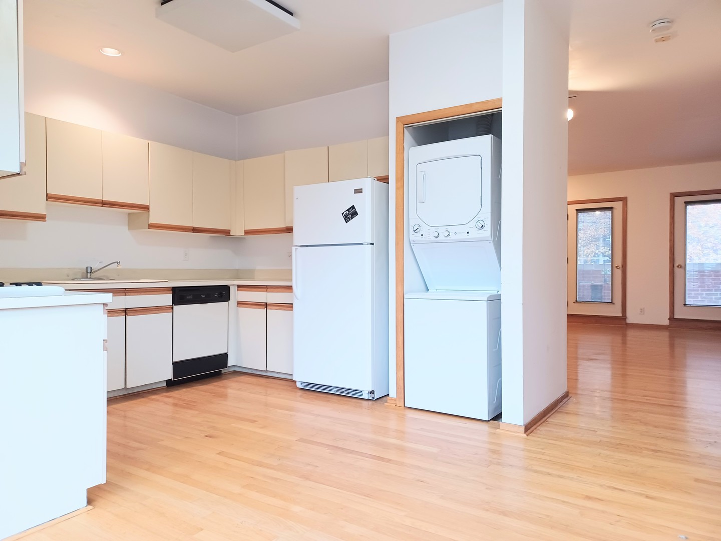 727 South Ashland Avenue, Unit D Chicago, IL 60607 - Photo 8 of 32 a kitchen with white cabinets and wooden floor