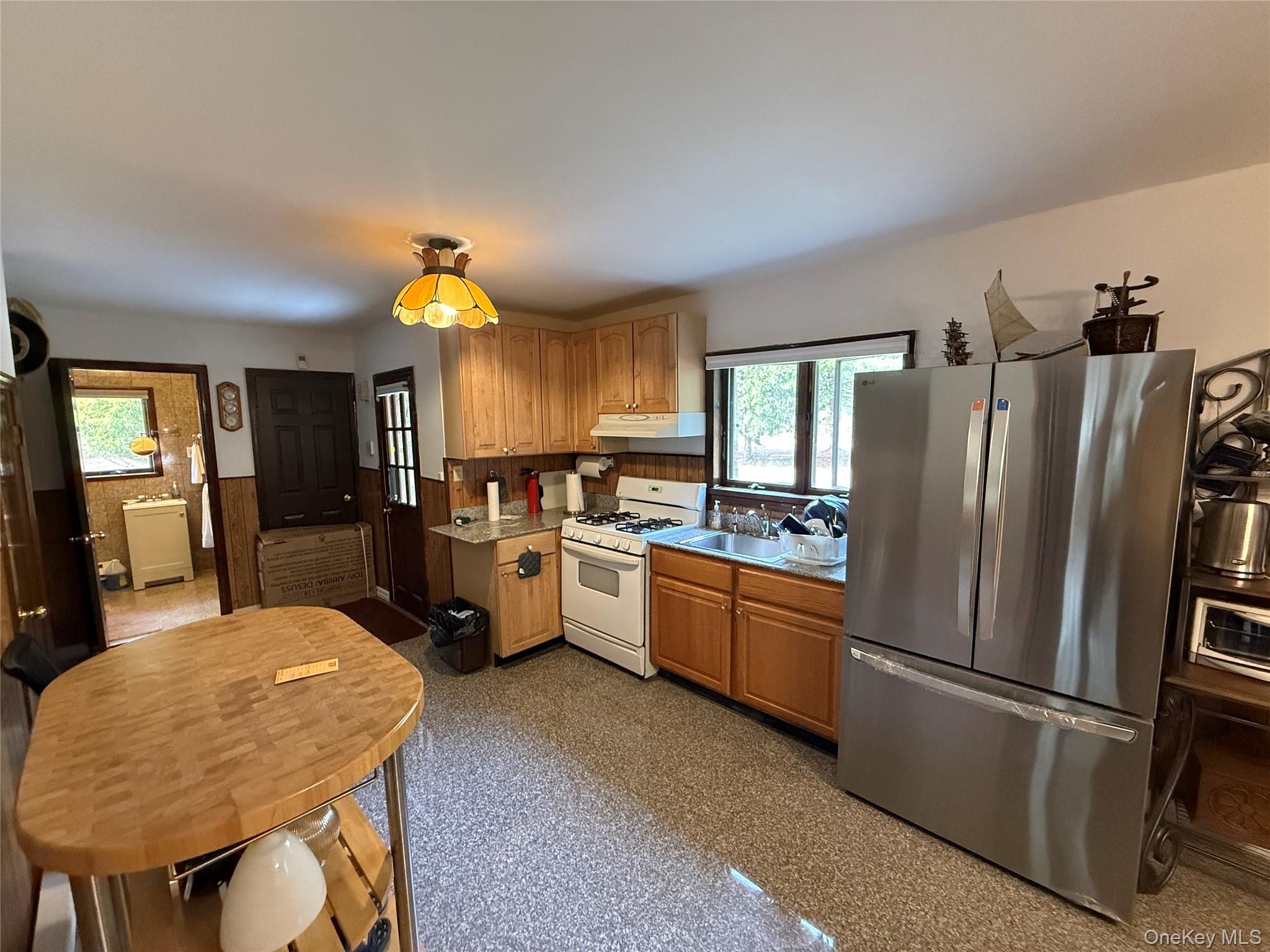 1441 Ulster Heights Road Ellenville, NY 12428 - Photo 4 of 35 a kitchen with stainless steel appliances granite countertop a refrigerator a sink dishwasher a stove a dining table and chairs with wooden floor