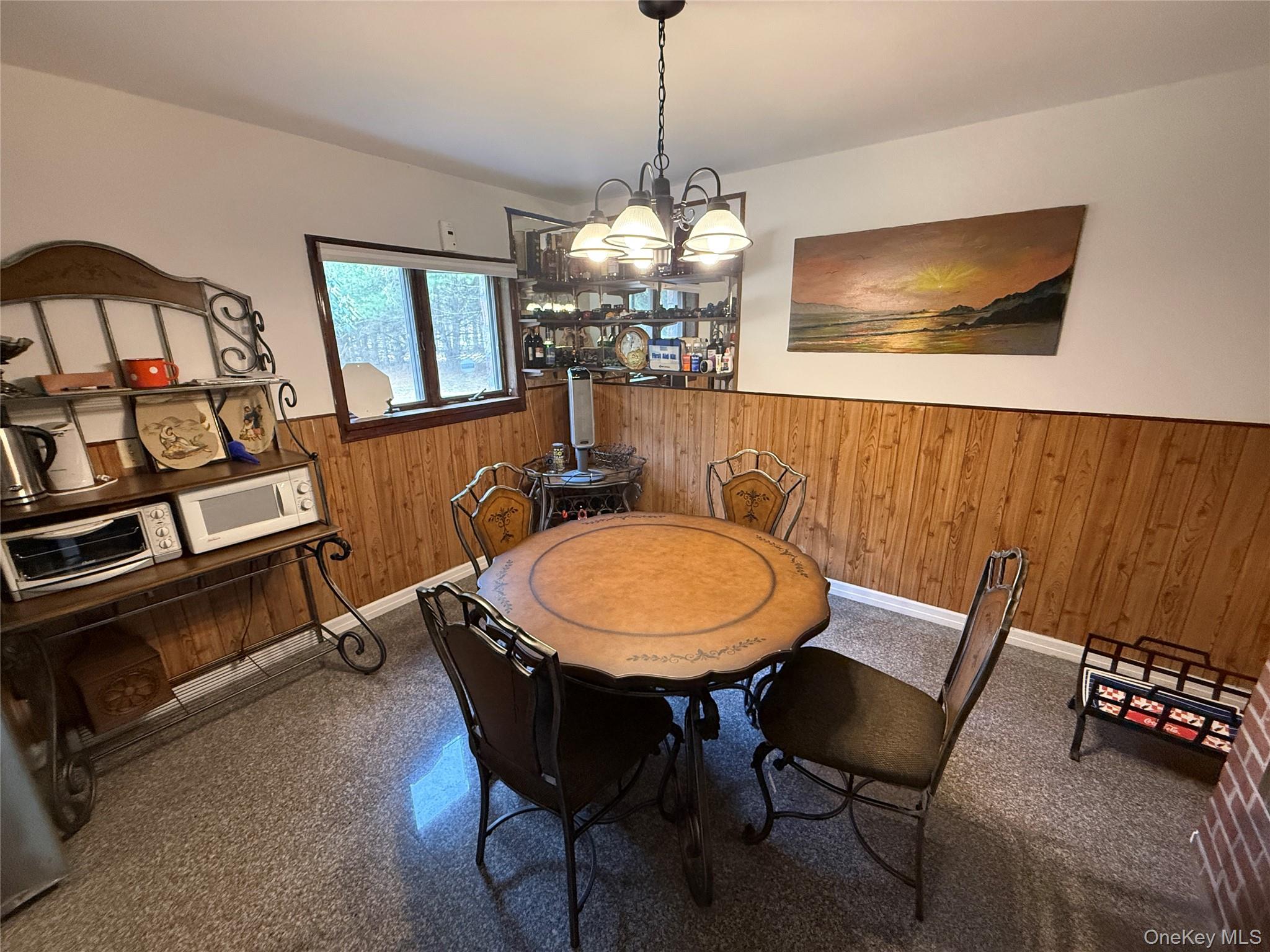 1441 Ulster Heights Road Ellenville, NY 12428 - Photo 8 of 35 a view of a dining room with furniture a chandelier and wooden floor
