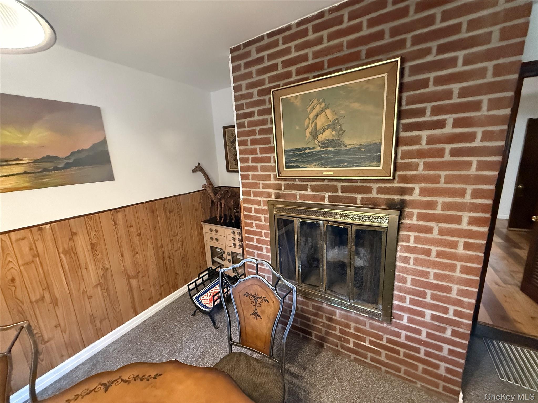 1441 Ulster Heights Road Ellenville, NY 12428 - Photo 9 of 35 a living room with a fireplace wooden floor and furniture