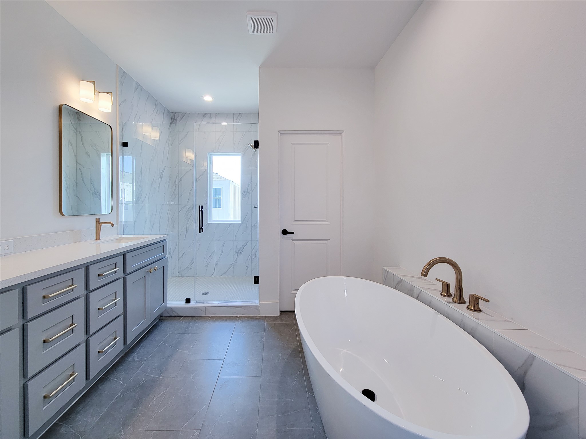 7705 Earl Rudder Way Houston, TX 77055 - Photo 17 of 39 a bathroom with a double vanity sink and mirror with bathtub