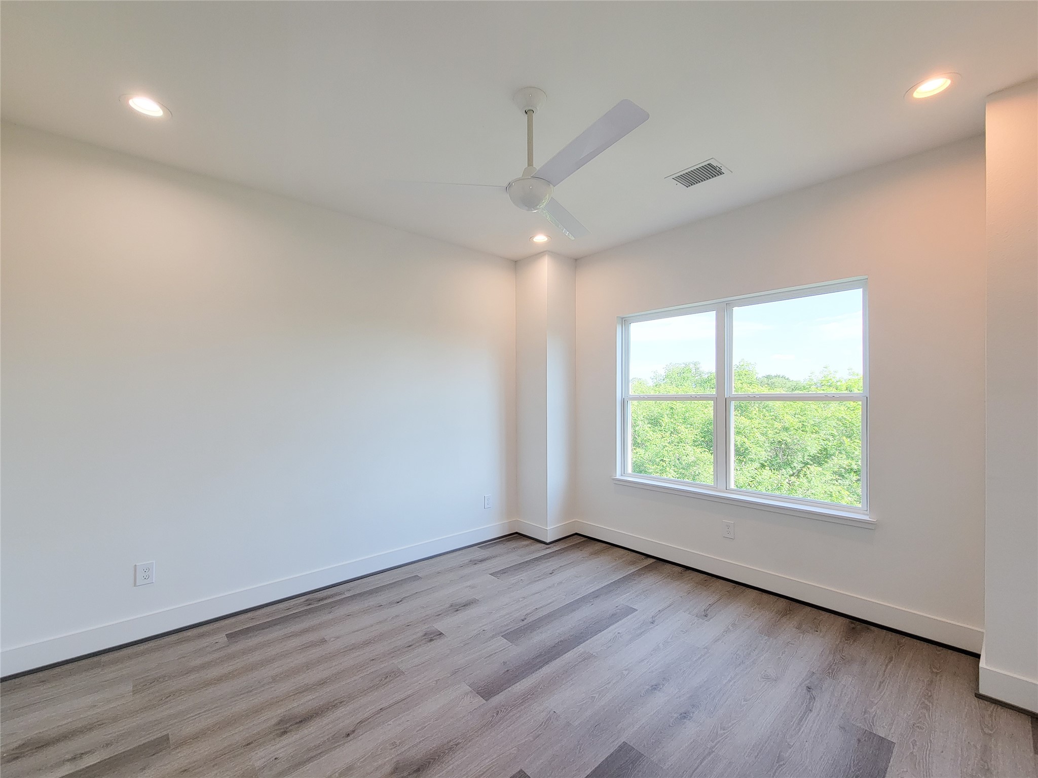 7705 Earl Rudder Way Houston, TX 77055 - Photo 24 of 39 an empty room with wooden floor and windows