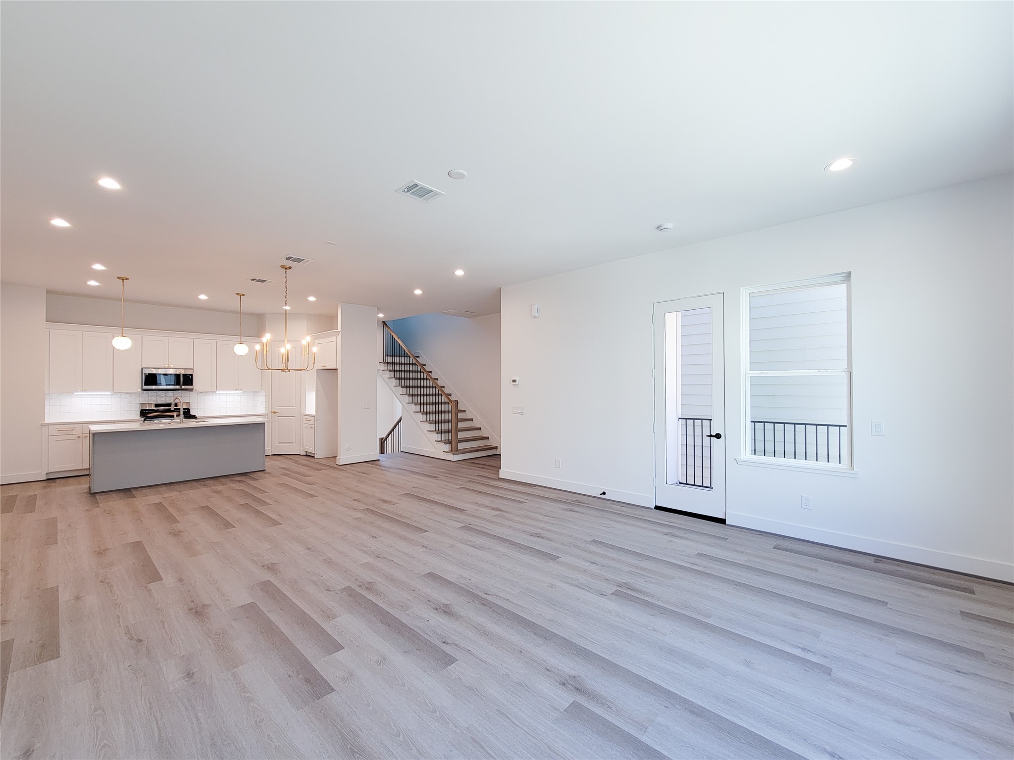 7705 Earl Rudder Way Houston, TX 77055 - Photo 25 of 39 a view of kitchen and hall with wooden floor