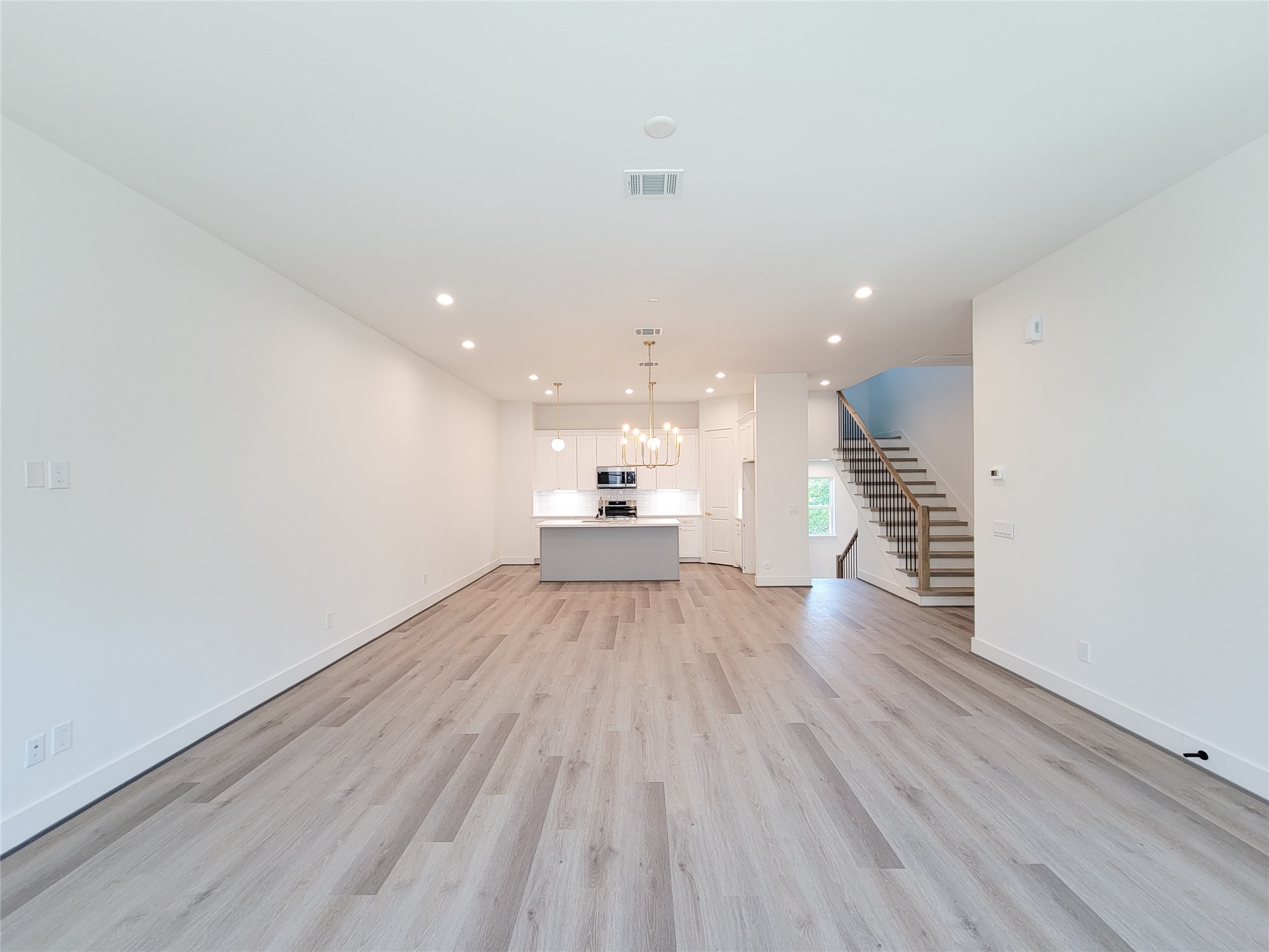 7705 Earl Rudder Way Houston, TX 77055 - Photo 26 of 39 a view of a room with wooden floor and kitchen view