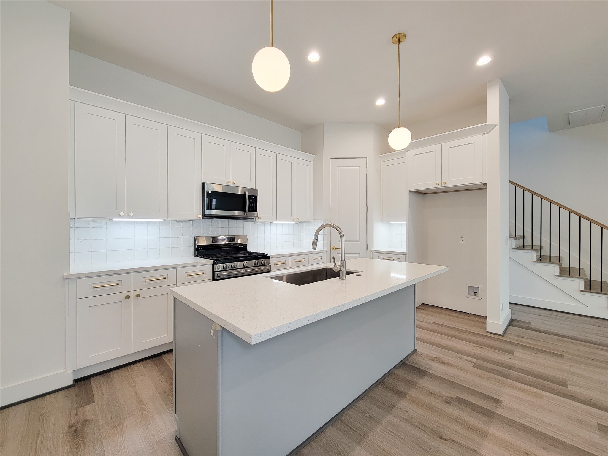 7705 Earl Rudder Way Houston, TX 77055 - Photo 29 of 39 a kitchen with a sink stainless steel appliances and white cabinets