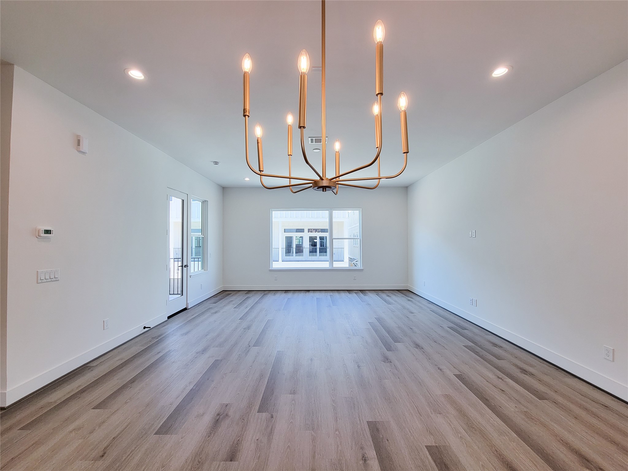 7705 Earl Rudder Way Houston, TX 77055 - Photo 37 of 39 an empty room with wooden floor and windows