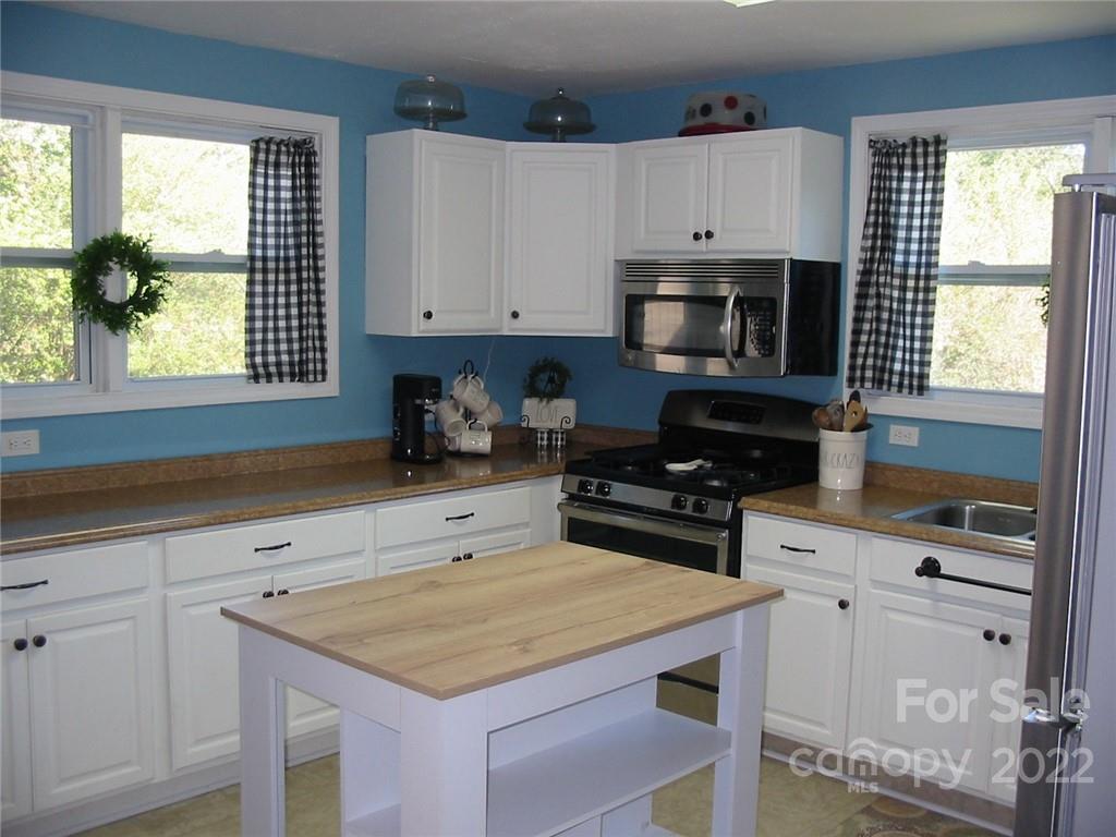 4366 Edgeland Road Edgemoor, SC 29712 - Photo 7 of 37 a kitchen with cabinets appliances a sink and a window