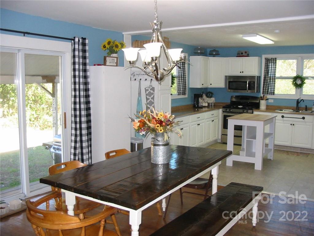4366 Edgeland Road Edgemoor, SC 29712 - Photo 10 of 37 a kitchen with stainless steel appliances granite countertop a dining table and chairs