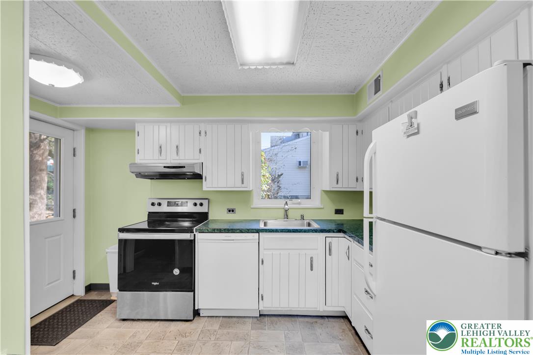 1130 Spring Street Bethlehem, PA 18018 - Photo 23 of 42 a kitchen with stainless steel appliances a refrigerator sink and cabinets