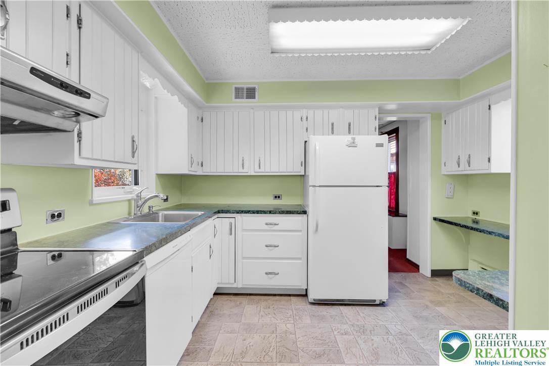 1130 Spring Street Bethlehem, PA 18018 - Photo 25 of 42 a white refrigerator freezer sitting inside of a kitchen