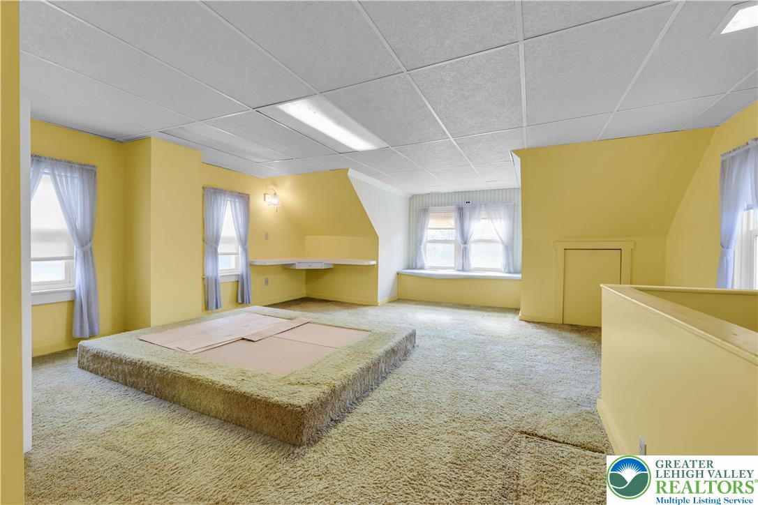 1130 Spring Street Bethlehem, PA 18018 - Photo 38 of 42 a spacious bedroom with a bed and a couch