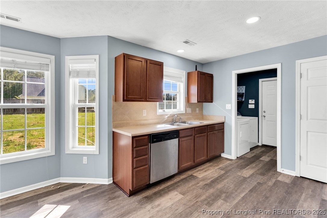 229 Cape Fear Road Raeford, NC 28376 - Photo 16 of 46 a large kitchen with stainless steel appliances granite countertop a sink and a stove top oven