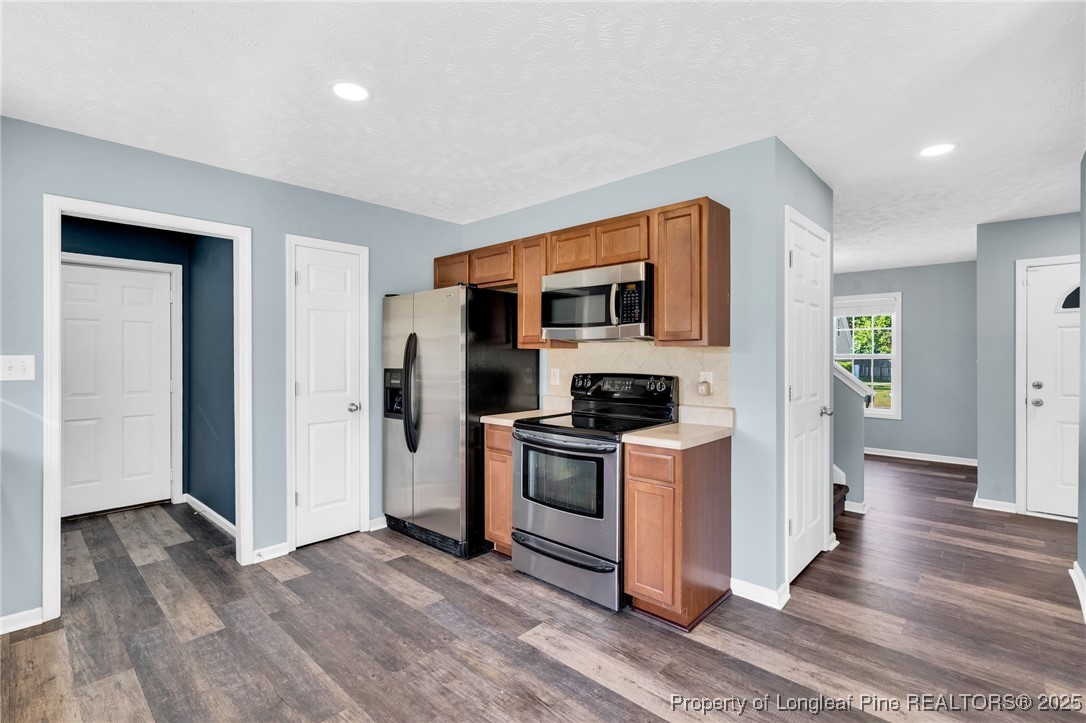 229 Cape Fear Road Raeford, NC 28376 - Photo 17 of 46 a kitchen with a stove a refrigerator and a sink