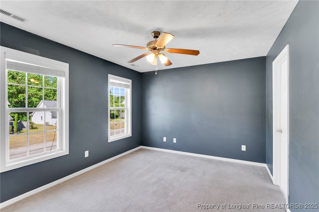 229 Cape Fear Road Raeford, NC 28376 - Photo 23 of 46 a view of an empty room with window and chandelier fan