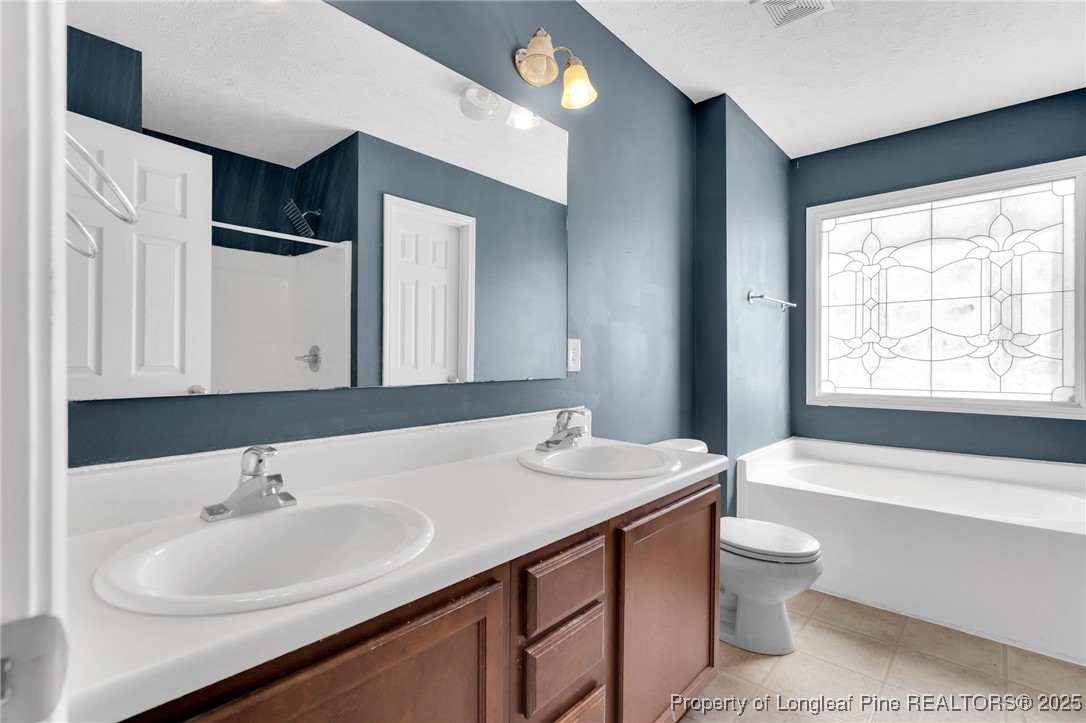 229 Cape Fear Road Raeford, NC 28376 - Photo 25 of 46 a bathroom with a sink and a large mirror