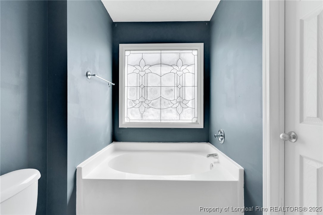 229 Cape Fear Road Raeford, NC 28376 - Photo 26 of 46 a white bath tub sitting in a bathroom next to a window