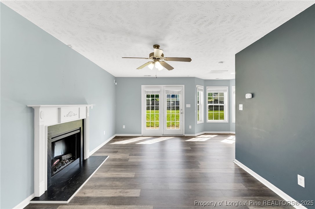 229 Cape Fear Road Raeford, NC 28376 - Photo 8 of 46 a view of an empty room with wooden floor fireplace and a window