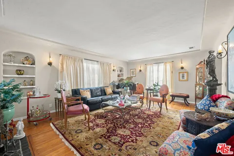 a view of a dining room with furniture a chandelier and wooden floor
