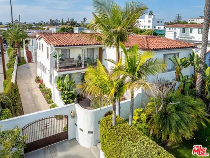 a front view of a multi story residential apartment building with swimming pool and glass windows
