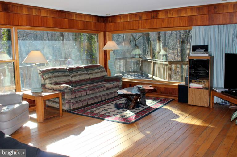 a living room filled with furniture and a fireplace