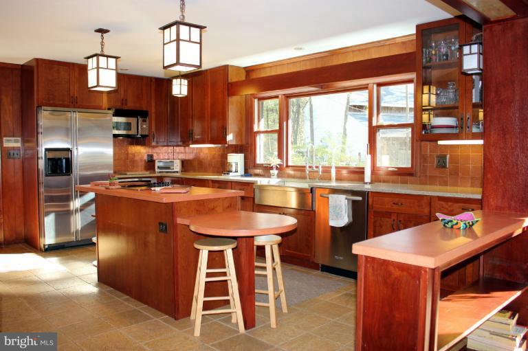 3046 Powder Mill Road Hyattsville, MD 20783 - Photo 2 of 20 a kitchen with a sink a kitchen island a stove and a refrigerator