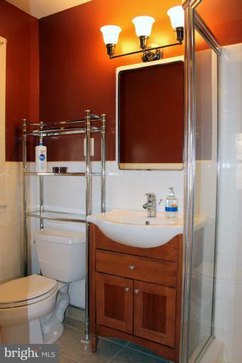 3046 Powder Mill Road Hyattsville, MD 20783 - Photo 11 of 20 a bathroom with a sink a toilet and mirror