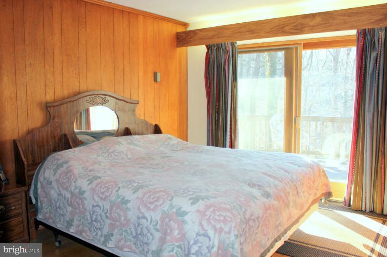 3046 Powder Mill Road Hyattsville, MD 20783 - Photo 14 of 20 a large bed sitting in a bedroom next to a window