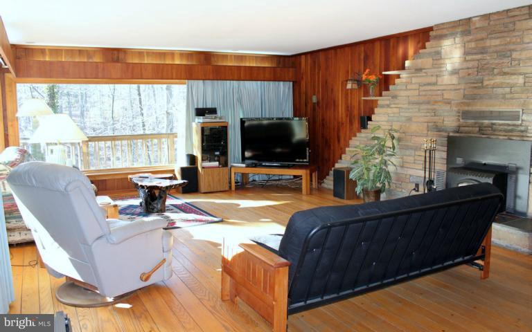 3046 Powder Mill Road Hyattsville, MD 20783 - Photo 16 of 20 a living room with furniture a flat screen tv and a large window