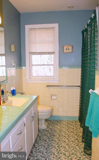 3046 Powder Mill Road Hyattsville, MD 20783 - Photo 19 of 20 a bathroom with a granite countertop toilet a sink and a shower