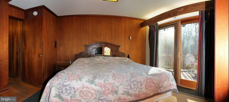 3046 Powder Mill Road Hyattsville, MD 20783 - Photo 3 of 20 a bedroom with a bed and wooden floor