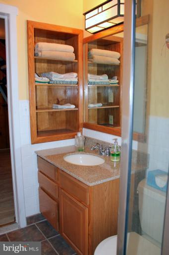 3046 Powder Mill Road Hyattsville, MD 20783 - Photo 7 of 20 a bathroom with a granite countertop sink and a mirror