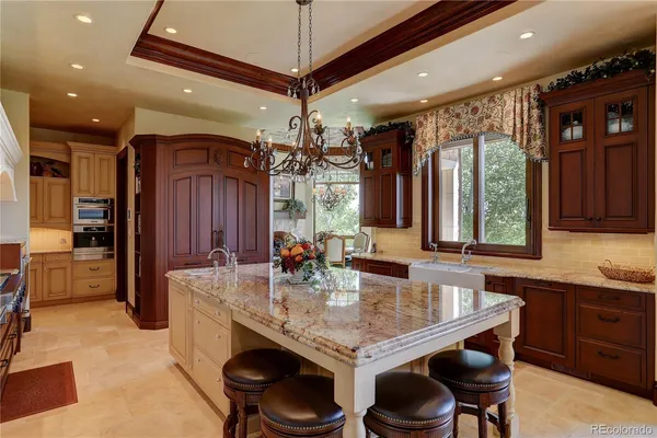 a kitchen with sink table and chairs