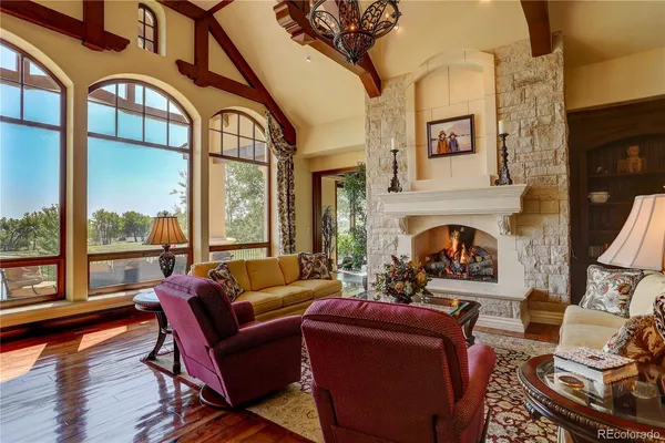 a living room with furniture fireplace and a large window
