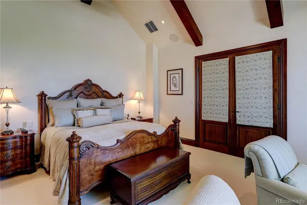 a bedroom with bed couch and window