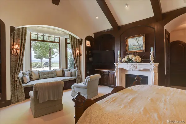 a bedroom with furniture and a large window